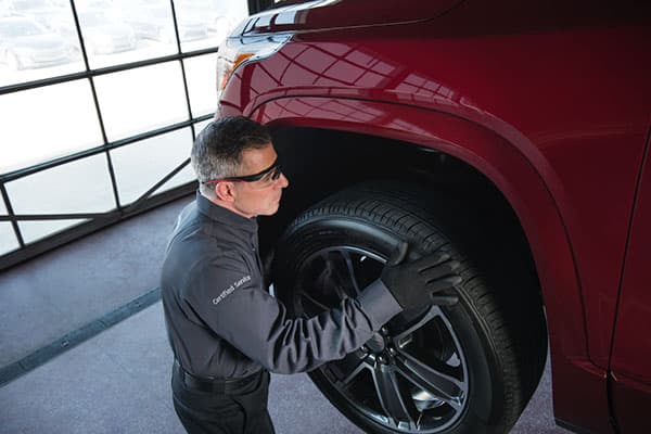 Service technician installing a new tire.