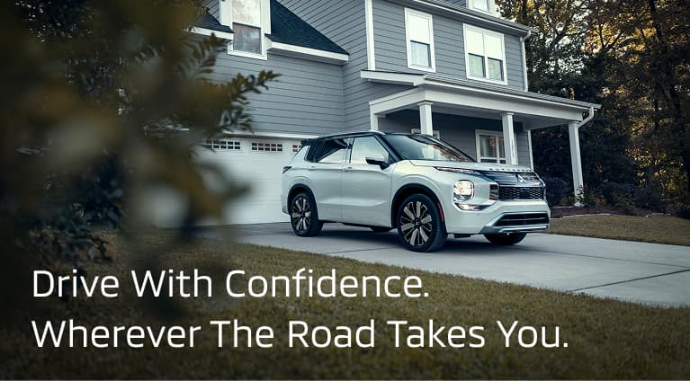 Still shot of a silver 2026 Outlander in a driveway