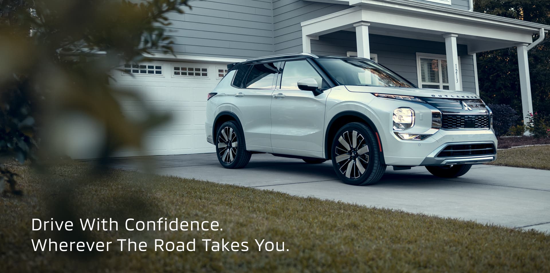 Still shot of a silver 2026 Outlander in a driveway