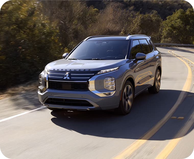 Front shot of the 2026 Outlander PHEV on a scenic road
