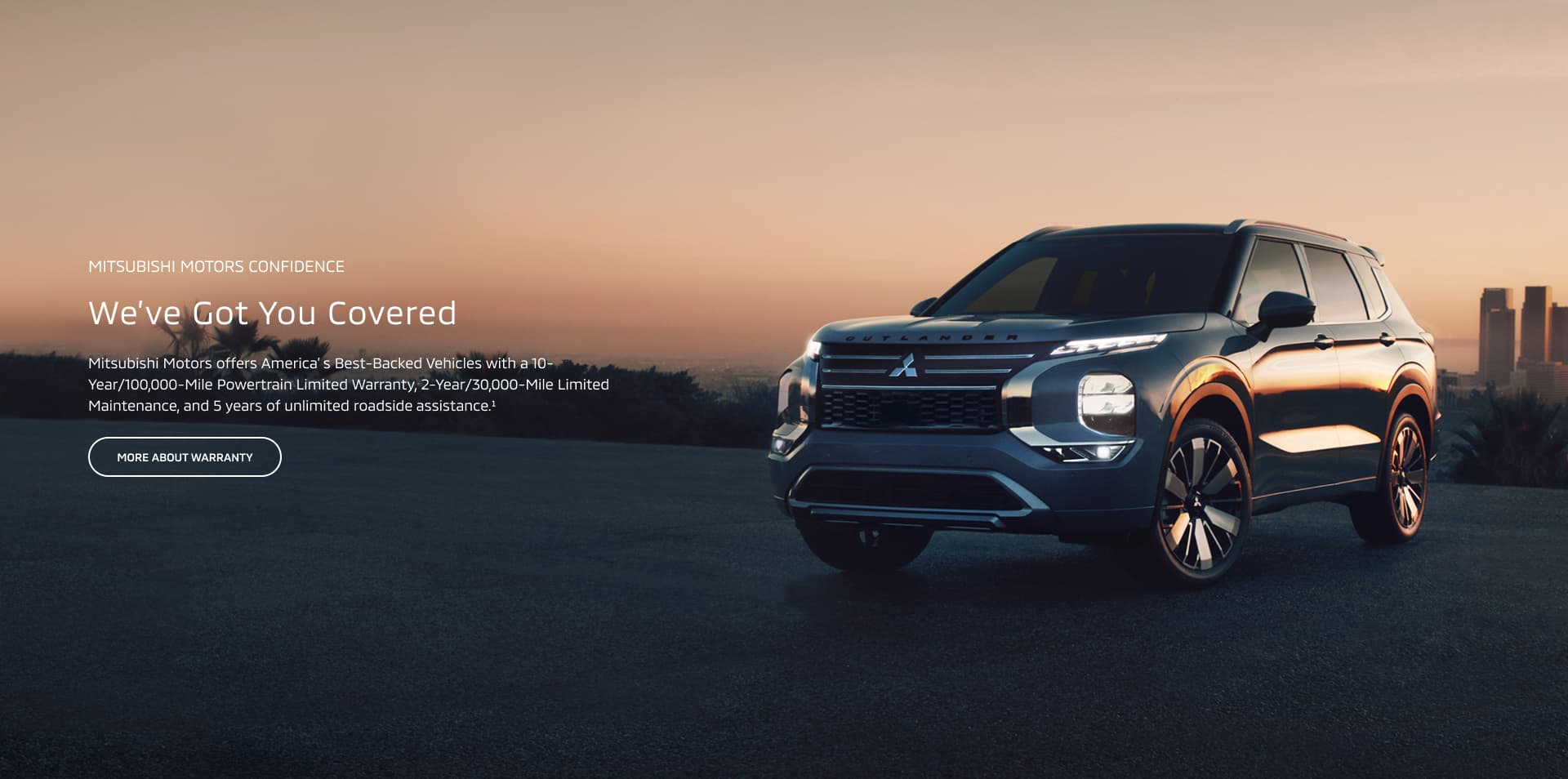 Sunset image of the 2026 Outlander on a cliff with a city background