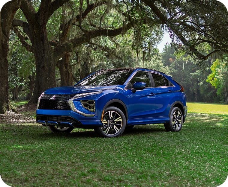 Blue Eclipse Cross parked in a field